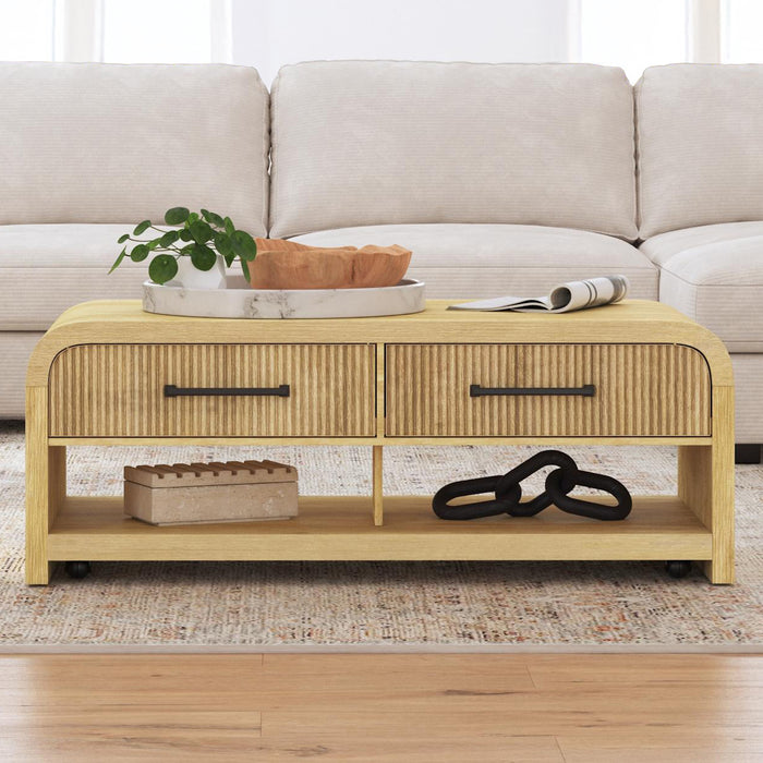 Ridgemont Coffee Table with Casters/Push Through Drawer in Natural - Jack’s Furniture and More (Laredo, TX)